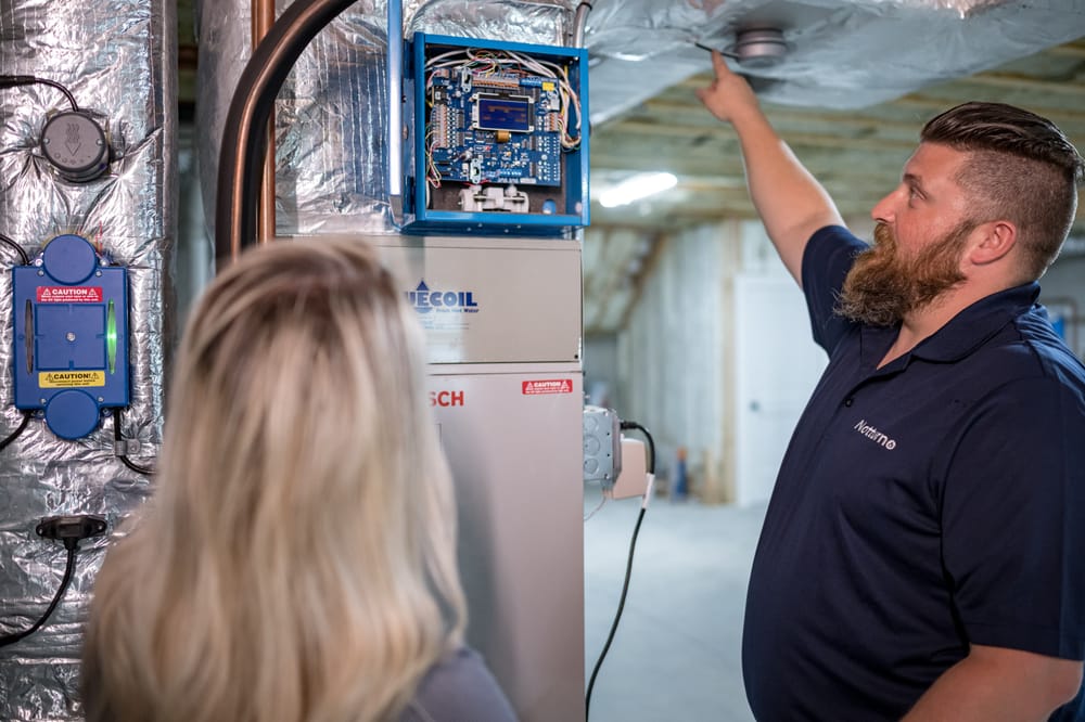 Notturno staff member inspecting HVAC system.