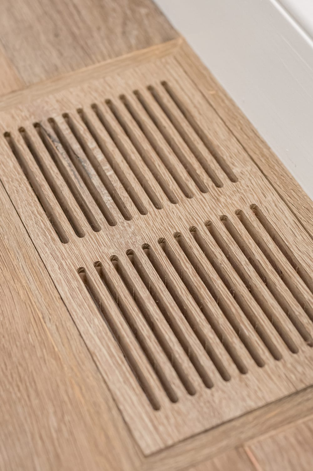Wooden vent in the floor inspected during air quality service appointment.