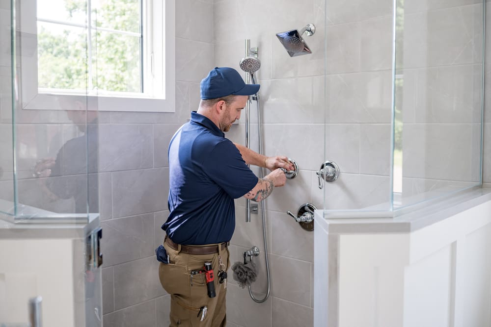 Plumber repairing shower.