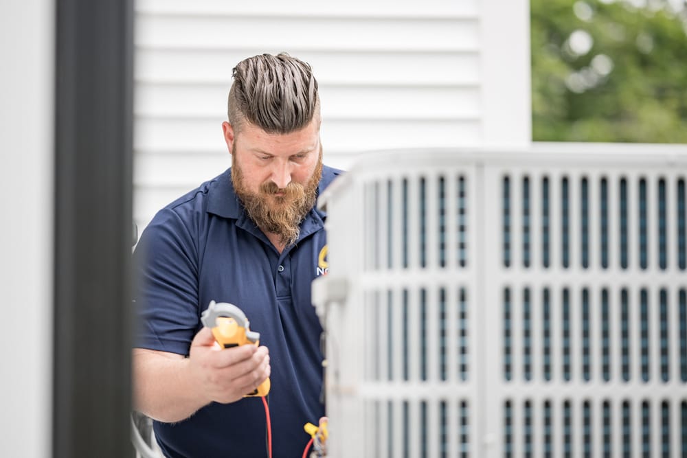 HVAC tech performing seasonal services on HVAC unit.