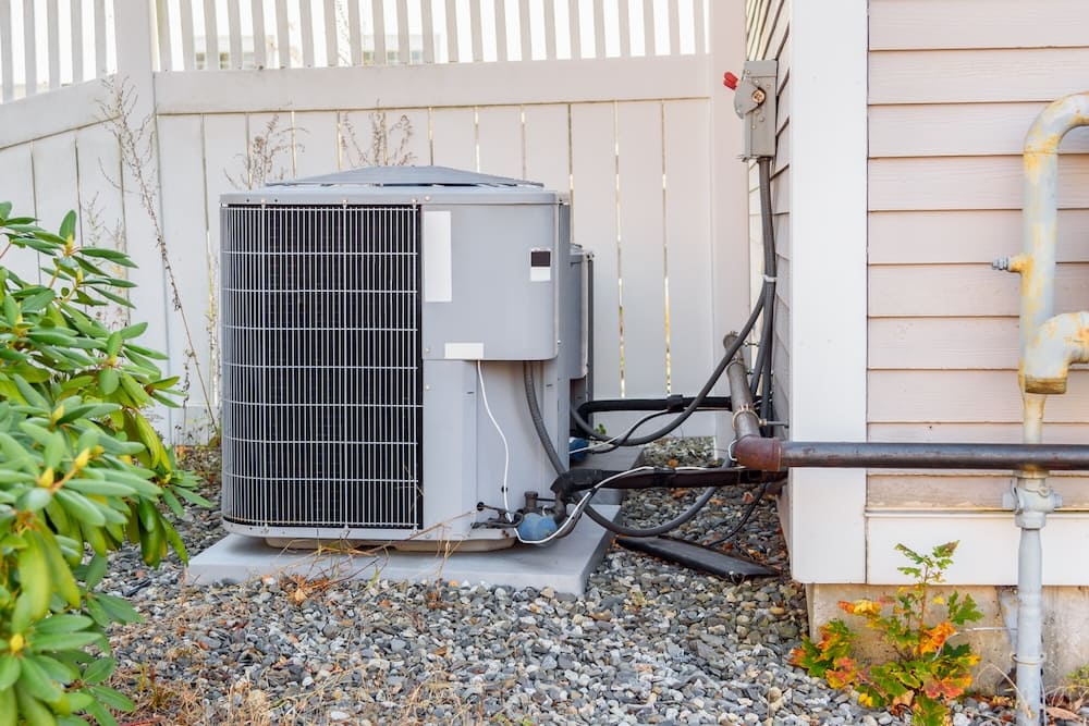 outdoor air conditioning unit on the side of a house