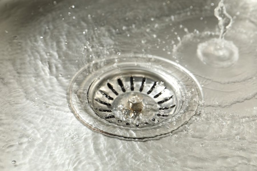 Kitchen sink drain with water flowing down it