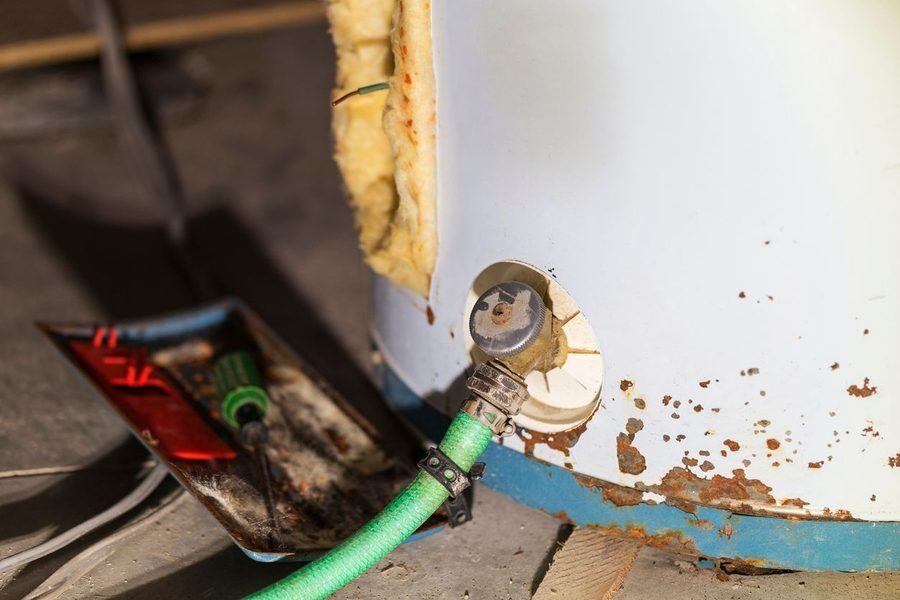 Old, rusty water heater in need of maintenance and repair
